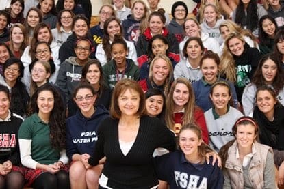 Group of smiling students with a teacher.